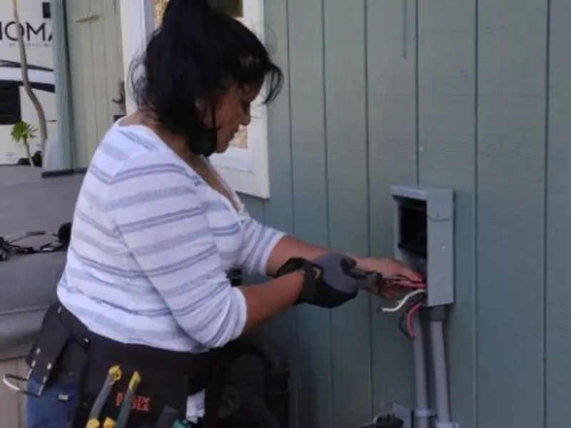 Licensed electrician wiring an exterior subpanel in Laramie